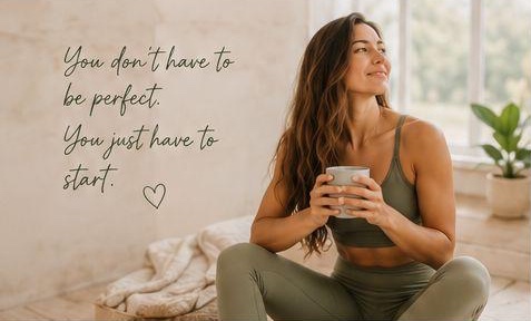 May sitting cross-legged holding a cup of tea